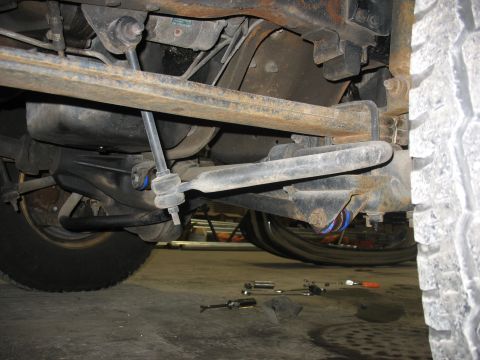 1995 Ford C-350 (Centurion Conversions) - Close-up view of the suspension system and undercarriage of a heavy-duty truck.
