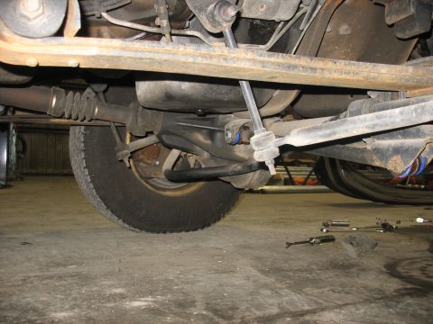 1995 Ford C-350 (Centurion Conversions) - A close-up view of the undercarriage reveals suspension and drivetrain parts, including the driveshaft and sway bar.
