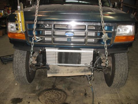 1995 Ford C-350 (Centurion Conversions) - Frontal view of a dark green 1995 Ford C-350 (Centurion Conversions) with its grille and exposed radiator.