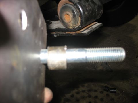 1995 Ford C-350 (Centurion Conversions) - A close-up view shows a threaded bolt extending from a metal plate, with a suspension component visible in the background.