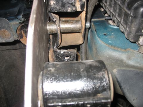 1995 Ford C-350 (Centurion Conversions) - Close-up view of a suspension component, likely a bushing and bracket, on a vehicle's frame.