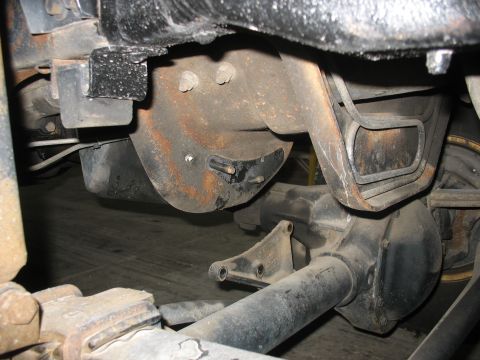 1995 Ford C-350 (Centurion Conversions) - Underside view of a vehicle's rear axle and suspension system, focusing on the differential and leaf spring mounts.