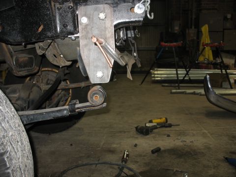 1995 Ford C-350 (Centurion Conversions) - A custom suspension bracket is shown attached to a vehicle's frame, with a leaf spring visible below.