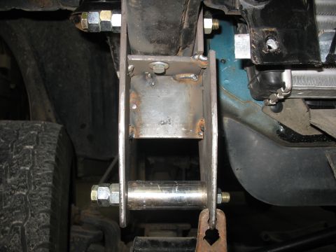 1995 Ford C-350 (Centurion Conversions) - Close-up view of a custom-fabricated suspension part, likely for off-road modification.