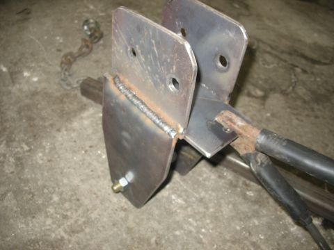 1995 Ford C-350 (Centurion Conversions) - Close-up view of a custom-welded metal bracket, possibly for a vehicle suspension modification.