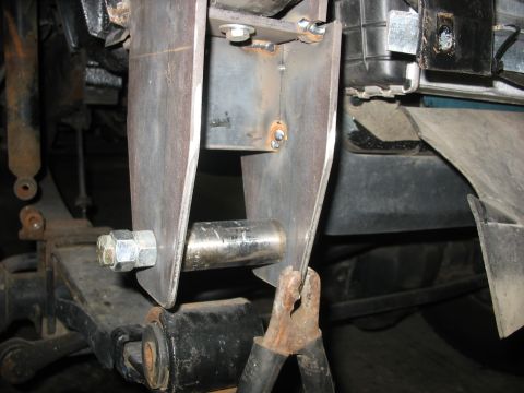 1995 Ford C-350 (Centurion Conversions) - Custom suspension part installation, showing a bolted bracket and a clamp.