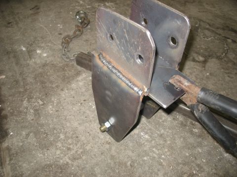 1995 Ford C-350 (Centurion Conversions) - Close-up of custom fabricated metal suspension components, possibly for a truck.