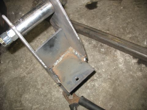 1995 Ford C-350 (Centurion Conversions) - Close-up of a custom-fabricated metal suspension part, showing welding and hardware.