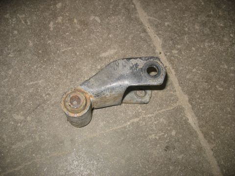 1995 Ford C-350 (Centurion Conversions) - A single metal suspension part with bushings is shown on a concrete floor.