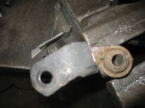 1995 Ford C-350 (Centurion Conversions) - A worn suspension component is secured in a vise, ready for modification or repair.
