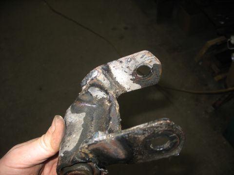 1995 Ford C-350 (Centurion Conversions) - A heavily modified and welded metal bracket, likely a suspension component, is shown in detail.
