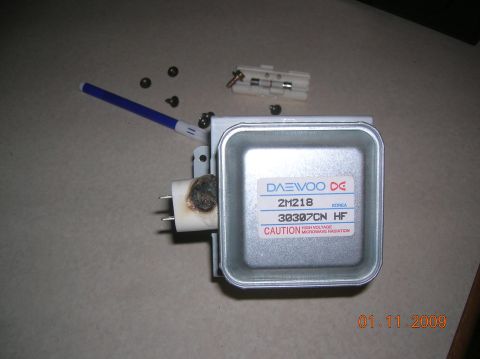 1985 Ford Bronco - A Daewoo magnetron part, likely from a microwave, with visible damage and caution labels.