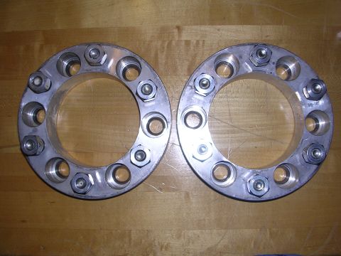 1983 Ferrari Enzo - Two brake rotors are shown on a wooden surface. No vehicle is visible.
