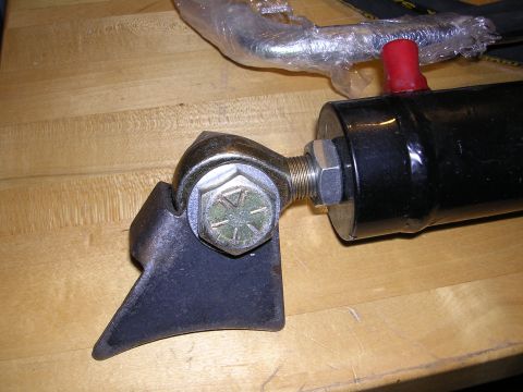 1983 Ferrari Enzo - Close-up of an automotive part, possibly a hydraulic cylinder, on a wooden surface.