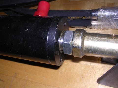 1983 Ferrari Enzo - Hydraulic cylinder part with hose and fittings visible, on a wooden surface.