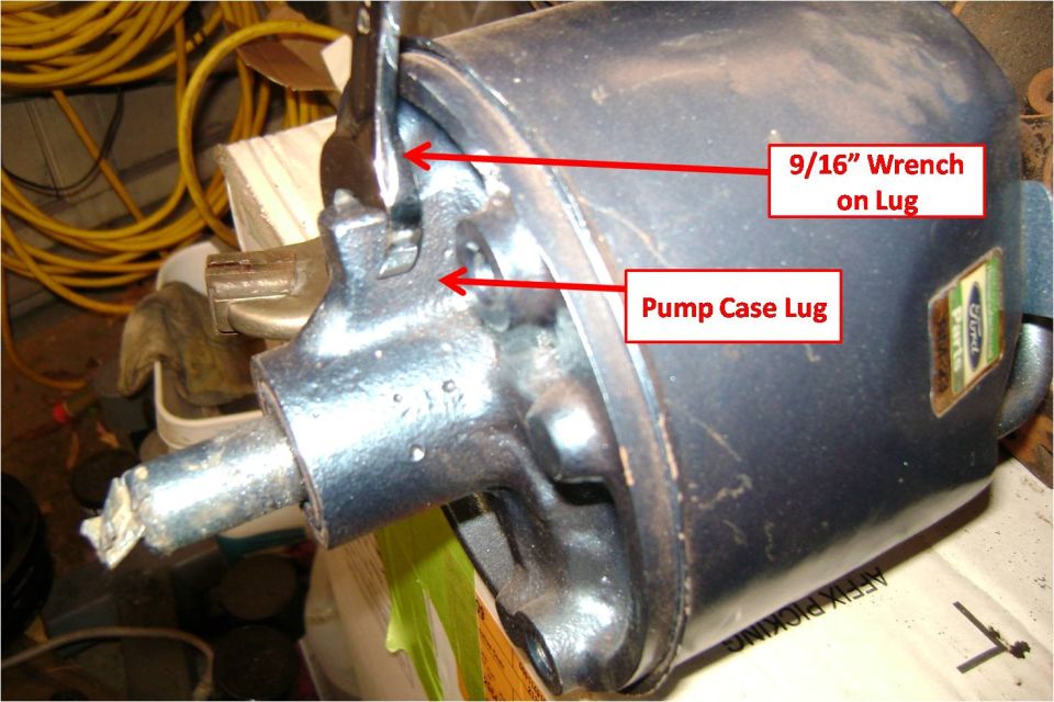 Blue power steering pump showing wrench seated on the case lug
