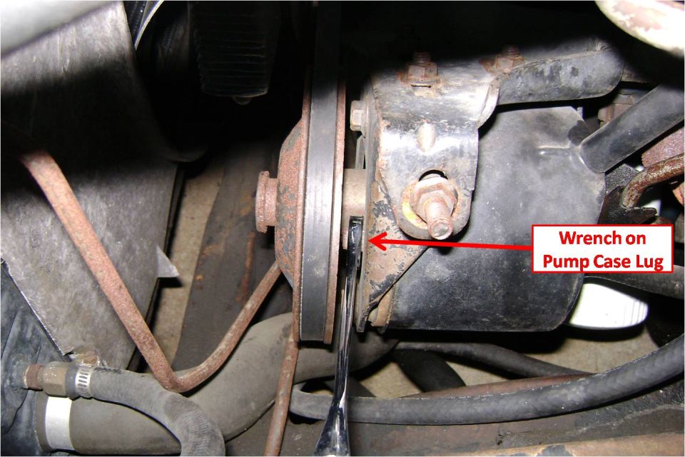 Under-hood power steering pump with wrench on the case lug