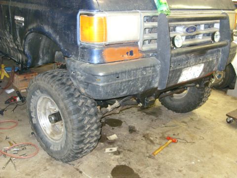 1988 Ford Bronco - This 1987 Ford Bronco features a prominent brush guard and large off-road tires, suggesting it is modified for terrain.