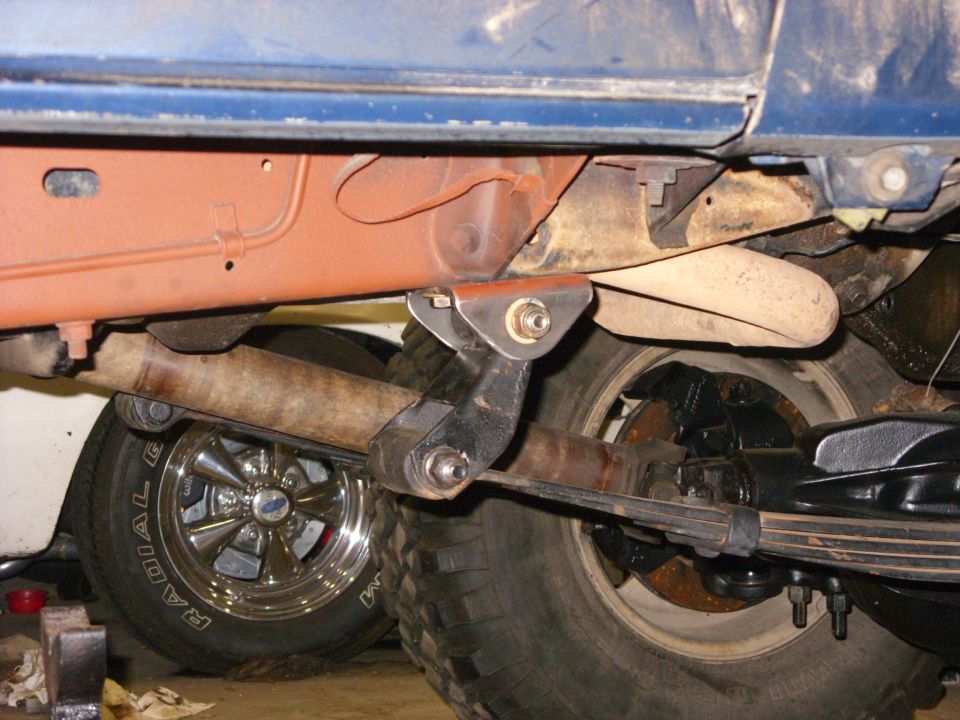 Blue vehicle undercarriage with leaf springs and exhaust pipe visible