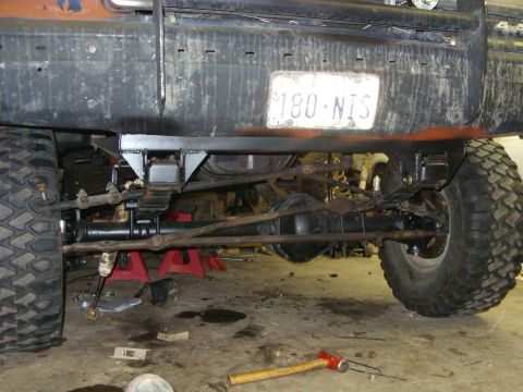 1988 Ford Bronco - Undercarriage view of a modified truck, showing suspension work and a license plate.
