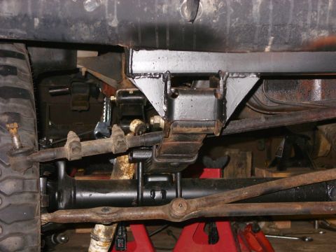 1988 Ford Bronco - Custom suspension modification on a 1988 Ford Bronco, focusing on the front leaf spring and steering components.