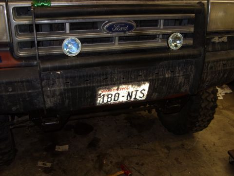 1988 Ford Bronco - The front of a 1987 Ford Bronco is visible, a bull bar and auxiliary lights.