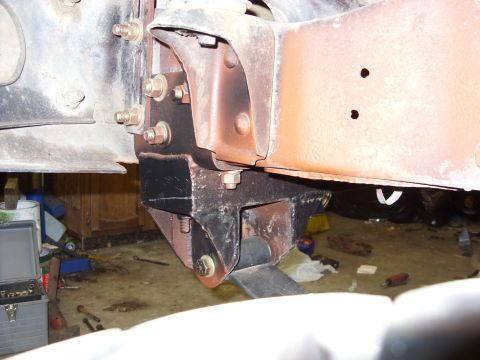 1988 Ford Bronco - Detail of a vehicle's undercarriage, showing frame and suspension parts.
