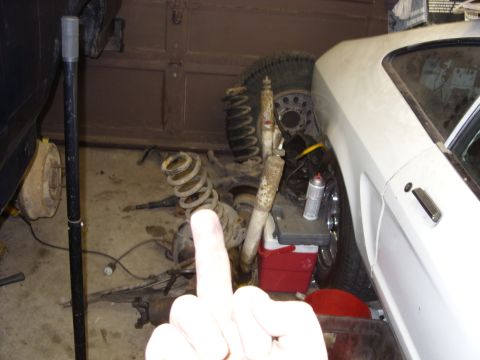 1988 Ford Bronco - Various automotive suspension components are visible in this garage setting.