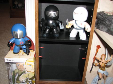 1991 Ford Bronco - A collection of G.I. Joe and Cobra Commander action figures displayed on shelves and boxes.