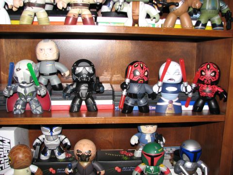 1991 Ford Bronco - A collection of Star Wars action figures are displayed on wooden shelves, characters like Darth Maul and Boba Fett.