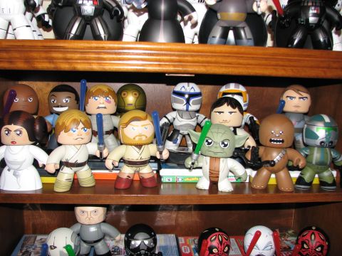1991 Ford Bronco - Star Wars figures, including Jedi and droids, are arranged on shelves above other collectibles.