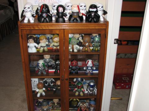 1991 Ford Bronco - A collection of Star Wars figures are displayed on the shelves of a wooden cabinet.