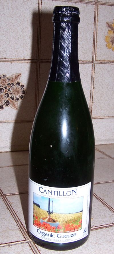 1990 Ford Bronco - A bottle of Cantillon Organic Gueuze is shown, a label with a pastoral scene of a field with poppies.