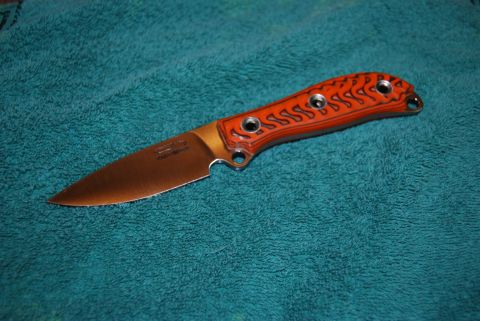 1991 Ford Bronco - Knife with orange handle and copper blade rests on a teal towel.