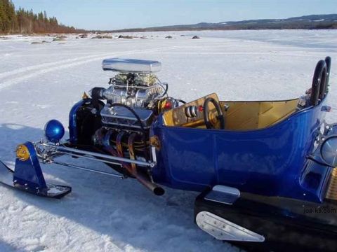 1989 Ford F-150 - A custom-built snowmobile with a powerful V8 engine is parked on a frozen, snow-covered area with trees in the background.