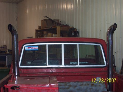 1978 Ford F-150 - Rear view of a red 1978 Ford F-150 pickup truck with large exhaust stacks.