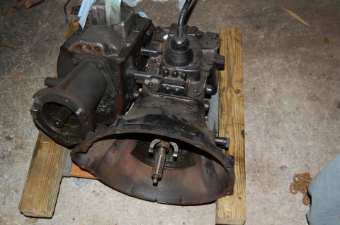 1994 Ford Bronco - A transmission and transfer case assembly is shown, mounted on wooden blocks for support.