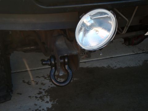 1995 Ford Bronco - Close-up of a tow hitch assembly with a D-ring shackle and an aftermarket light.
