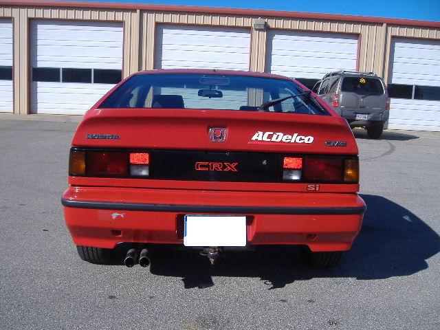Rear view of a red Honda CRX Si with AC/Delco badging.