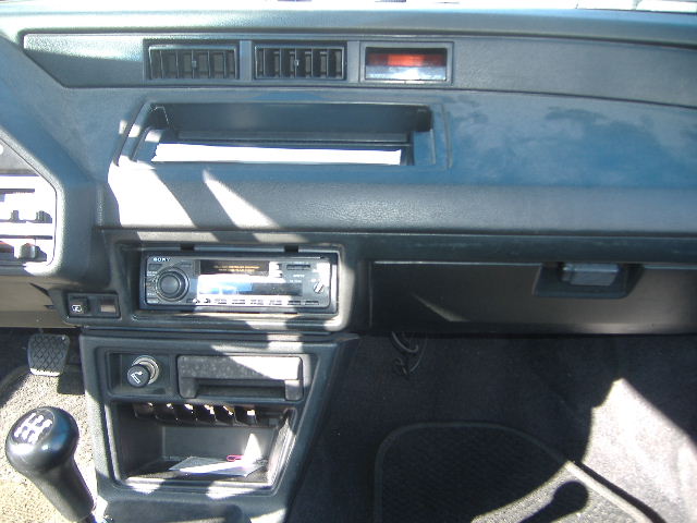 Car interior dashboard with Sony stereo, cigarette lighter, and gear shifter.