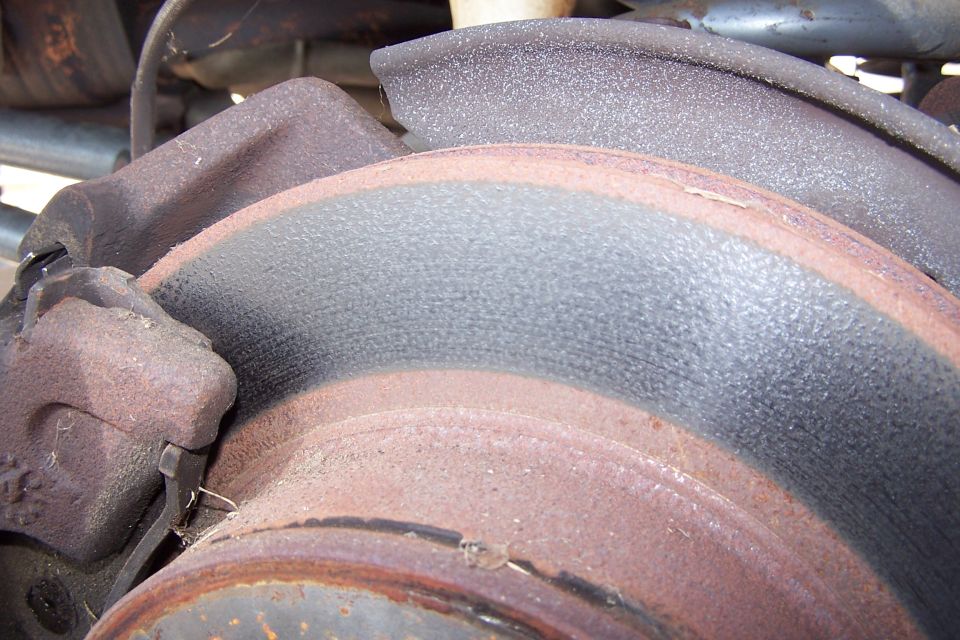 Rusted brake rotor and caliper assembly.