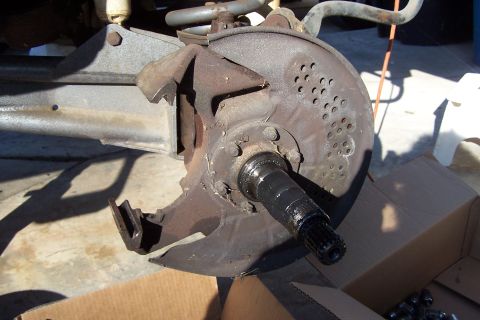 1990 Ford Bronco - Close-up view of a vehicle's front wheel hub assembly, showing the brake rotor and splined axle shaft.