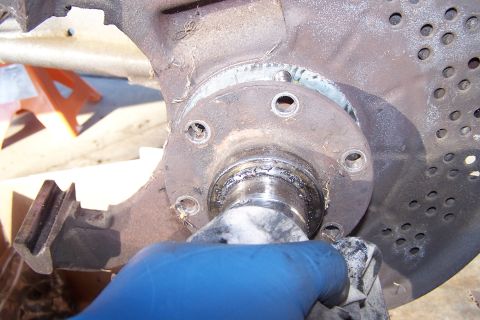 1990 Ford Bronco - Wheel hub and brake rotor assembly being cleaned, likely during maintenance or repair.