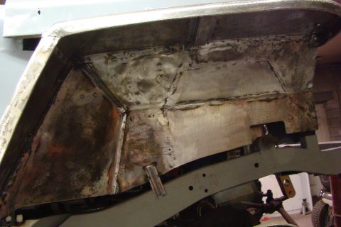1948 Jeep Wrangler - This image shows the underside of a vehicle's body and frame, likely during a repair or restoration process.