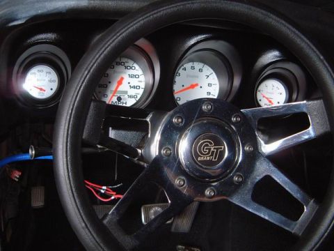 1970 Ford Mustang - Dashboard view of a 1970 Ford Mustang interior, a Grant GT steering wheel and multiple gauges.
