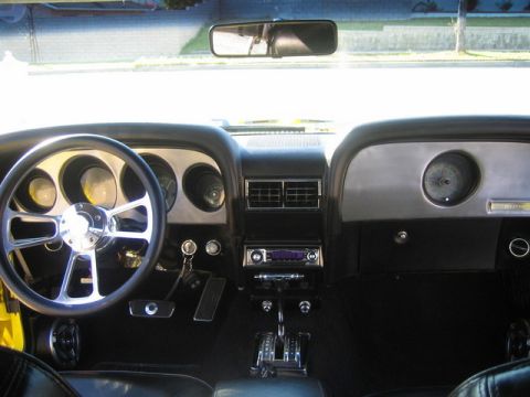 1970 Ford Mustang - The interior of a 1970 Ford Mustang shows an aftermarket steering wheel and a rebuilt dashboard.