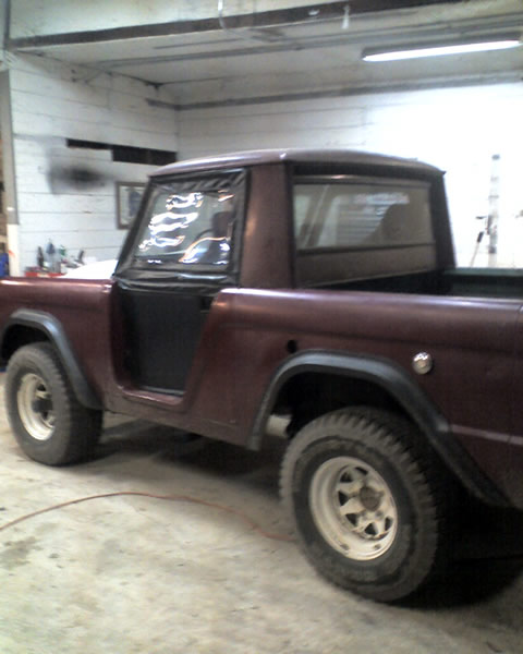1968 Ford Bronco - This 1968 Ford Bronco is seen in a garage with its doors removed and soft top windows installed.