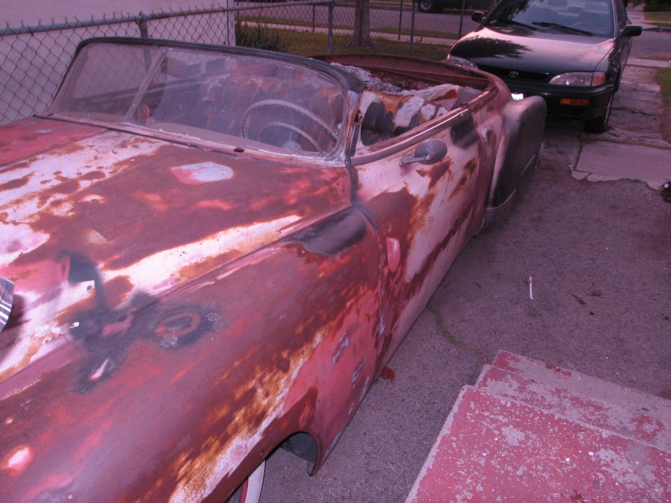 old rusty convertible car, another car parked behind it