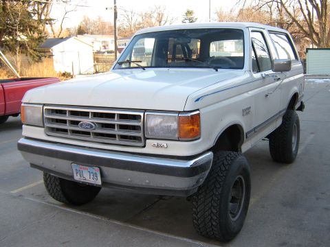 1987 Ford Bronco - This 1987 Ford Bronco features a lifted suspension and aggressive off-road tires, giving it a stance.