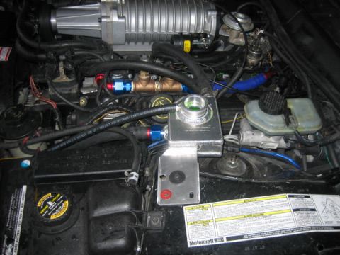 1996 Ford Thunderbird - Custom engine bay modifications are visible, including a supercharger and aftermarket plumbing, with a Motorcraft label present.